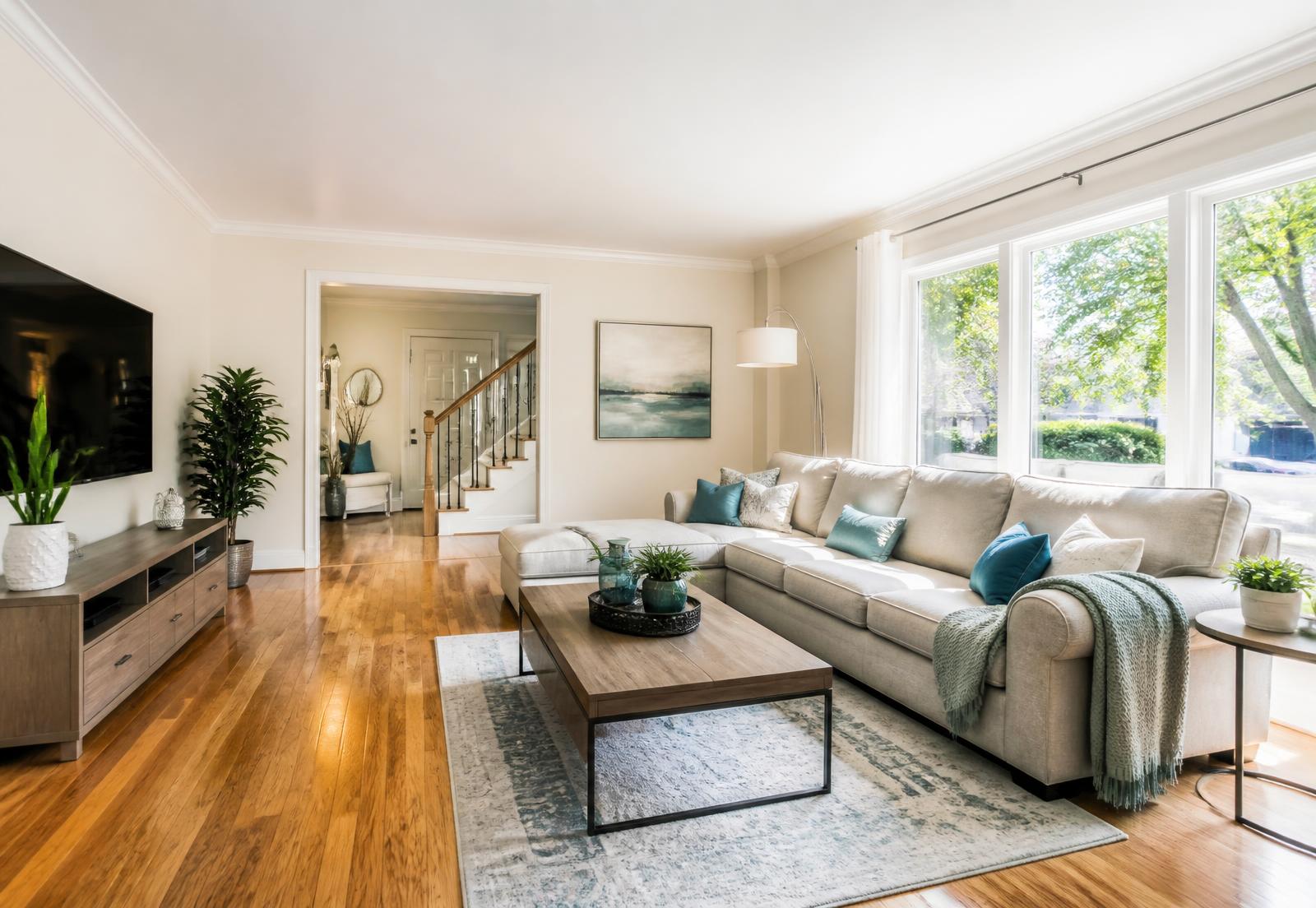 Bright, freshly cleaned Toronto living room with sunlight on polished hardwood floors